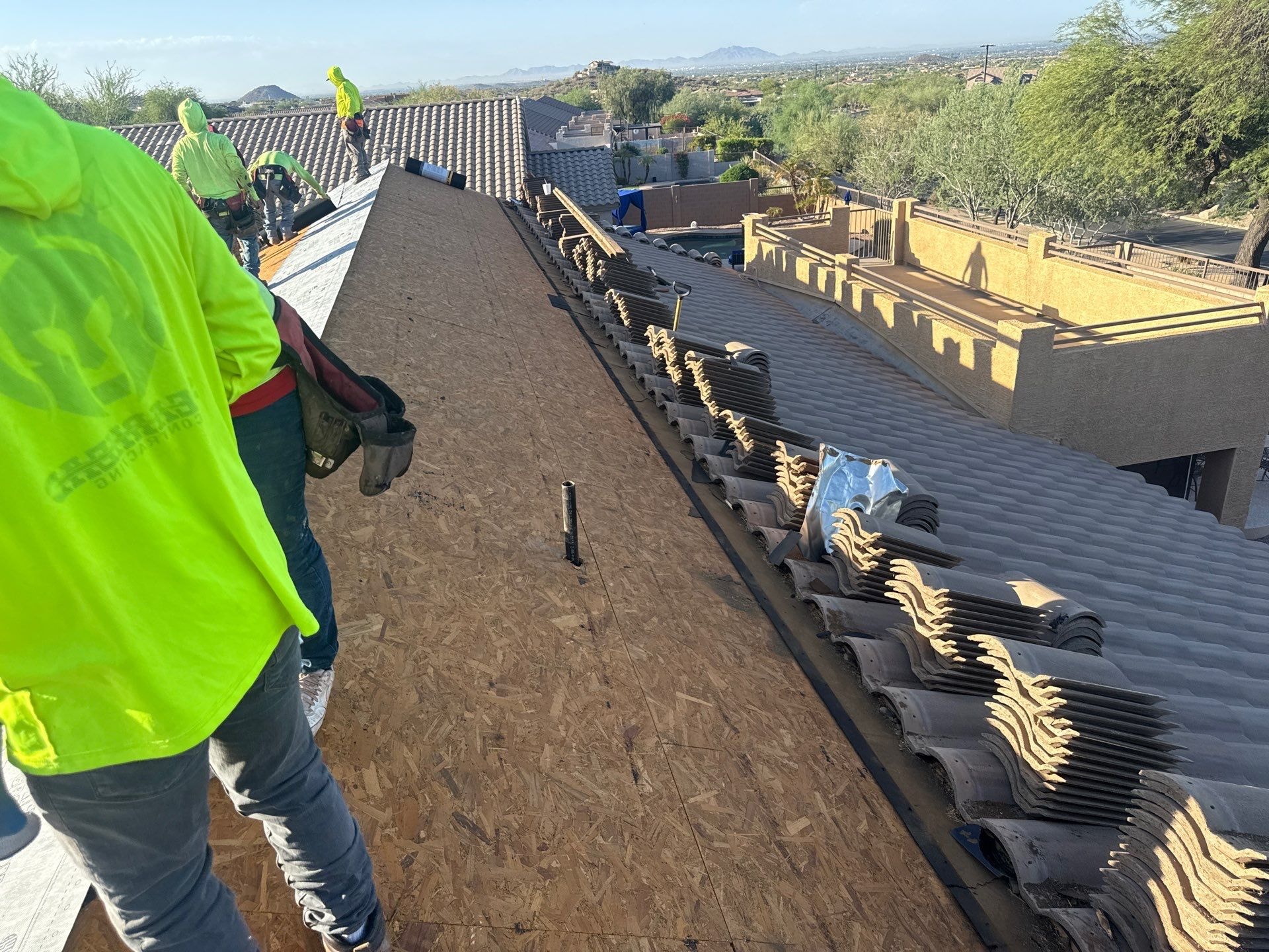 APM Builders team working on large estate tile roof